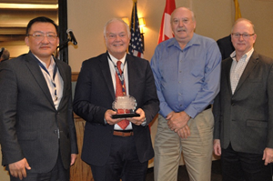 RRC Chairman Wayne Christian, joined by agency leadership team members, holds the IOGCC Award