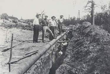 The Pick and Shovel Crew digging a pipeline ditch